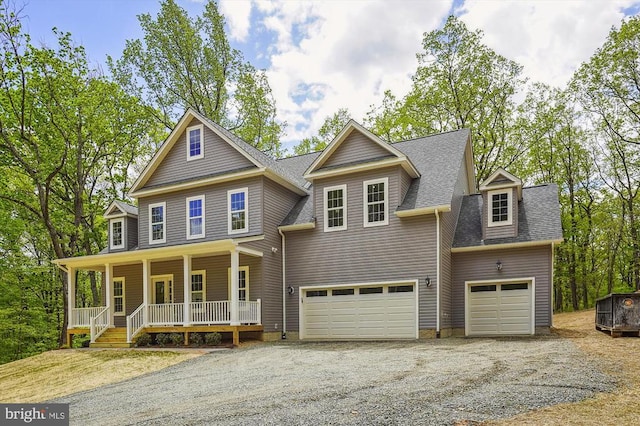  - view of front of home with a porch, driveway, roof with shingles, and a garage