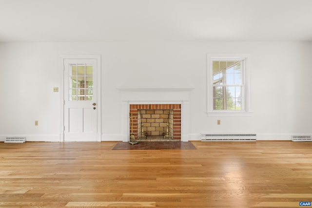 7928 Howardsville Rd, Scottsville, VA 24562 - unfurnished living room featuring wood finished floors, a baseboard radiator, and a fireplace