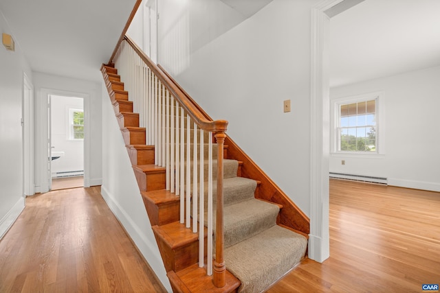7928 Howardsville Rd, Scottsville, VA 24562 - stairway with wood finished floors, a baseboard heating unit, and baseboard heating