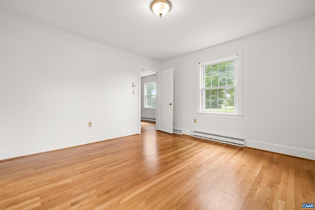 7928 Howardsville Rd, Scottsville, VA 24562 - spare room featuring a baseboard heating unit and light wood-style floors