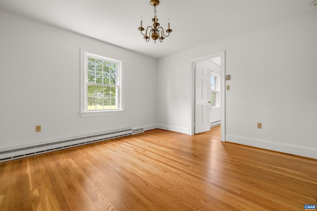 7928 Howardsville Rd, Scottsville, VA 24562 - unfurnished room featuring baseboard heating, a chandelier, light wood-type flooring, and a baseboard radiator