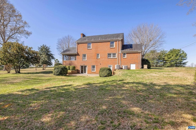 7928 Howardsville Rd, Scottsville, VA 24562 - rear view of property featuring brick siding, a chimney, a lawn, and a patio area
