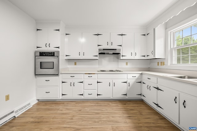7928 Howardsville Rd, Scottsville, VA 24562 - kitchen featuring stainless steel oven, white stovetop, under cabinet range hood, white cabinets, and light wood-type flooring