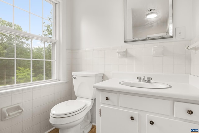 7928 Howardsville Rd, Scottsville, VA 24562 - half bathroom featuring tile walls, vanity, and a wainscoted wall