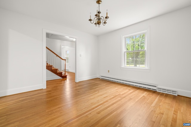 7928 Howardsville Rd, Scottsville, VA 24562 - unfurnished room with a baseboard radiator, stairs, light wood finished floors, and a chandelier