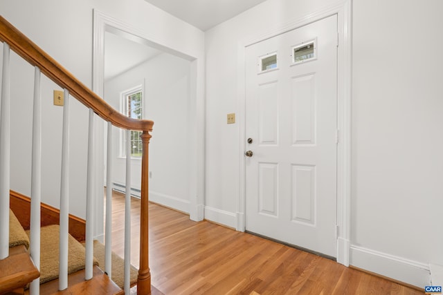 7928 Howardsville Rd, Scottsville, VA 24562 - foyer entrance featuring stairs, light wood-type flooring, and a baseboard radiator