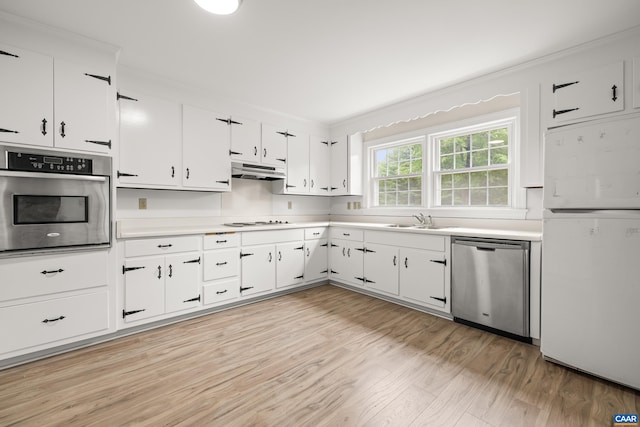 7928 Howardsville Rd, Scottsville, VA 24562 - kitchen with stainless steel appliances, light wood-style floors, light countertops, white cabinetry, and crown molding
