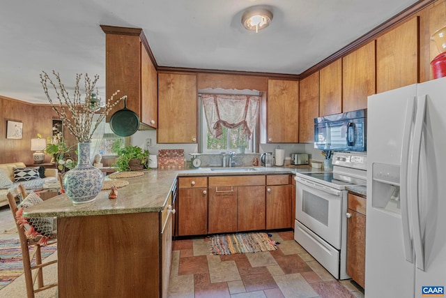 1842 Ed Jones Rd, Scottsville, VA 24590 - kitchen with white appliances, brown cabinets, a sink, a peninsula, and wood walls