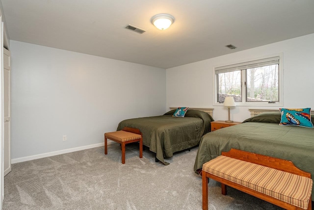 bedroom featuring light carpet and baseboards