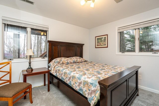bedroom with light colored carpet and baseboards