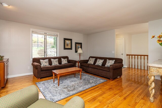 living room featuring light wood finished floors and baseboards