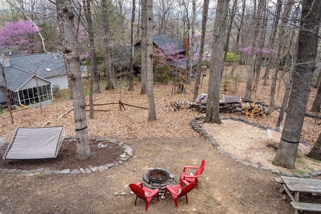 view of yard with a fire pit and a sunroom