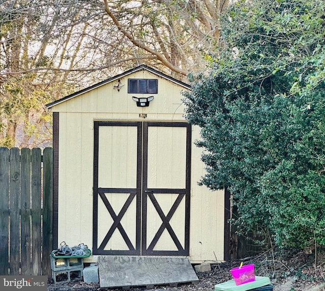 view of shed with fence