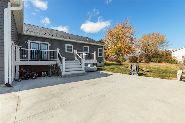 845 Forrest Dr, Stanley, VA 22851 - rear view of property featuring a lawn, a patio area, a deck, and metal roof