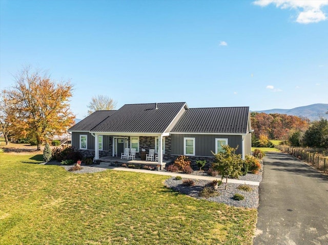 845 Forrest Dr, Stanley, VA 22851 - ranch-style home featuring a standing seam roof, metal roof, covered porch, stone siding, and a front yard