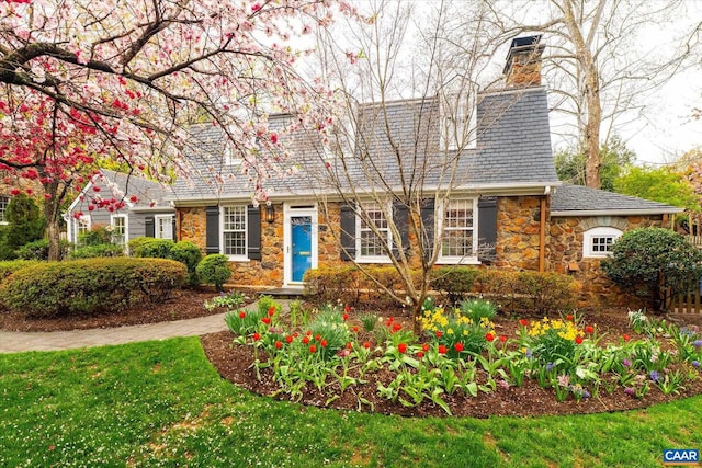 view of front of property featuring stone siding and a chimney
