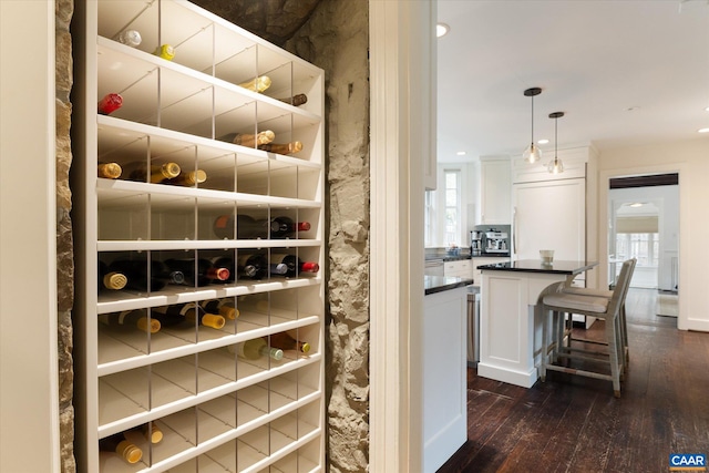 wine cellar with dark wood-style flooring and recessed lighting