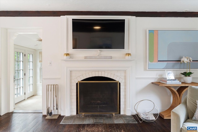 details featuring wood finished floors and a brick fireplace