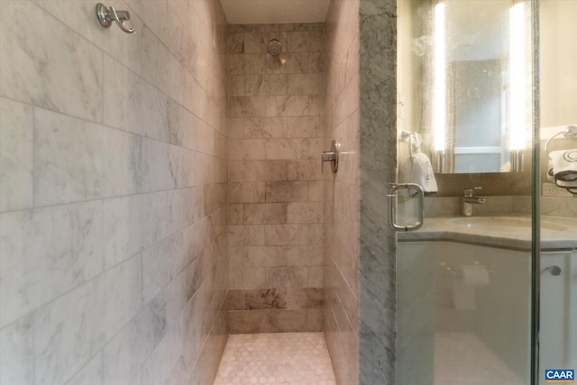 bathroom featuring a shower stall and a sink
