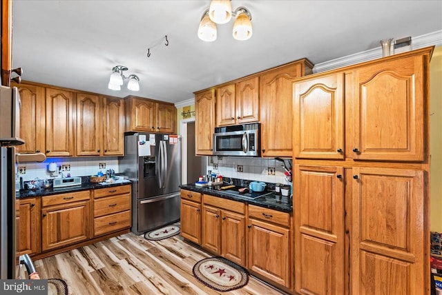 kitchen featuring appliances with stainless steel finishes, brown cabinetry, and tasteful backsplash