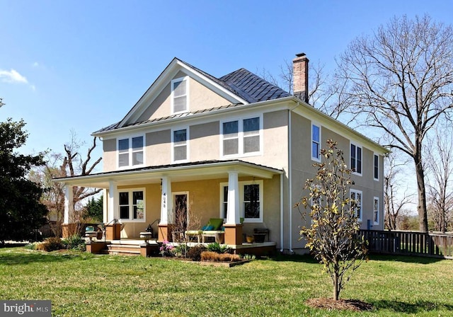  - view of front of home featuring covered porch, stucco siding, a chimney, a standing seam roof, and a metal roof