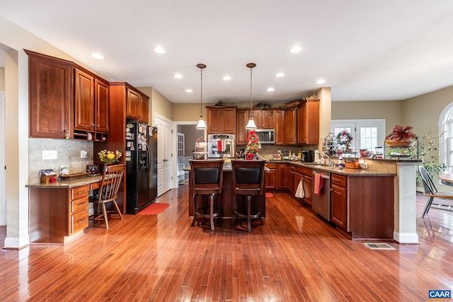 2 Forest Ct, Zion Crossroads, VA 22942 - kitchen with stainless steel appliances, a kitchen breakfast bar, dark wood-type flooring, a kitchen island, and decorative backsplash