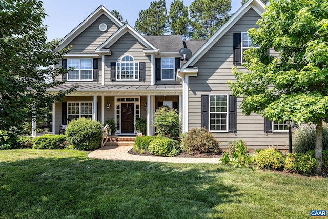2 Forest Ct, Zion Crossroads, VA 22942 - view of front of home with a front yard, a standing seam roof, covered porch, roof with shingles, and a metal roof