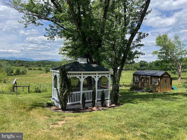 view of yard featuring a gazebo, an outbuilding, and a storage shed