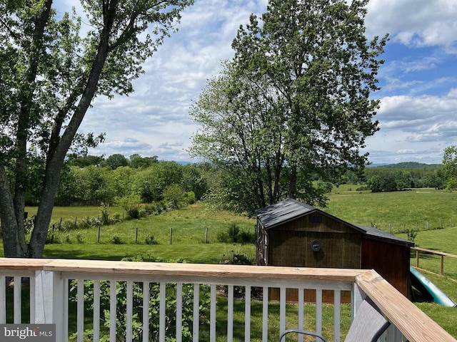 wooden deck featuring a rural view