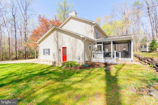11523 Red Rock Ln, Bumpass, VA 23024 - traditional home with a sunroom, a chimney, and a front lawn