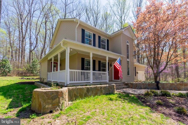 11523 Red Rock Ln, Bumpass, VA 23024 - farmhouse-style home with covered porch and a front lawn