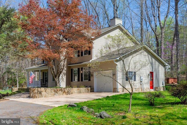 11523 Red Rock Ln, Bumpass, VA 23024 - view of front facade with asphalt driveway, a chimney, an attached garage, a front lawn, and a porch