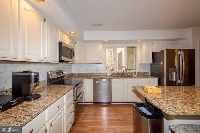 11523 Red Rock Ln, Bumpass, VA 23024 - kitchen with stainless steel appliances, light stone countertops, white cabinets, and recessed lighting