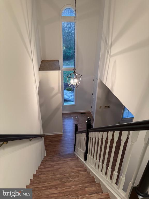 11523 Red Rock Ln, Bumpass, VA 23024 - stairway featuring wood finished floors and baseboards