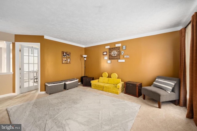 13104 Willow Point Dr, Fredericksburg, VA 22408 - living area with carpet floors, crown molding, a textured ceiling, ornate columns, and baseboards