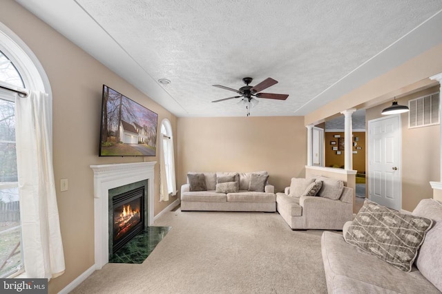 13104 Willow Point Dr, Fredericksburg, VA 22408 - living area featuring carpet floors, a textured ceiling, plenty of natural light, a fireplace with flush hearth, and a ceiling fan