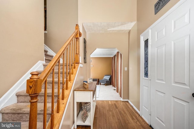 13104 Willow Point Dr, Fredericksburg, VA 22408 - staircase featuring arched walkways, wood finished floors, and baseboards