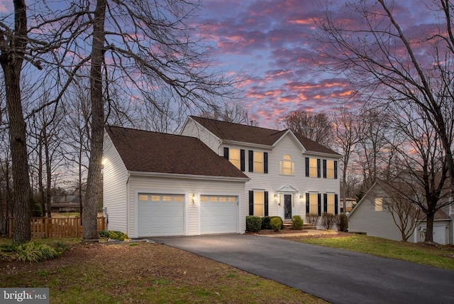 13104 Willow Point Dr, Fredericksburg, VA 22408 - colonial-style house featuring a garage, driveway, fence, and a shingled roof