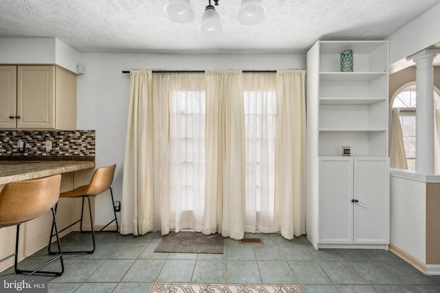 13104 Willow Point Dr, Fredericksburg, VA 22408 - dining space featuring a chandelier, a textured ceiling, and light tile patterned floors