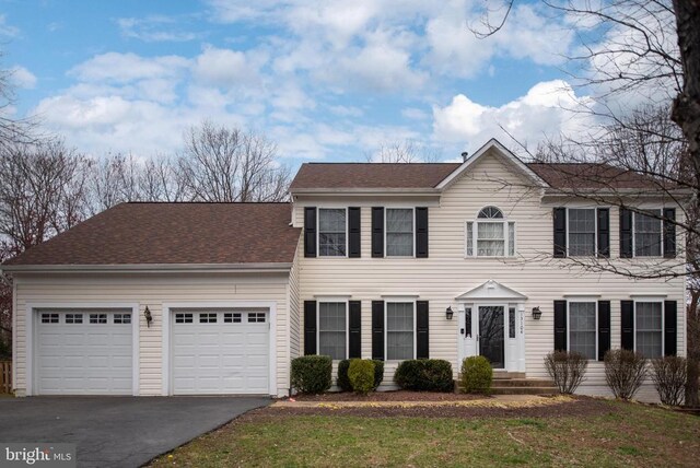 13104 Willow Point Dr, Fredericksburg, VA 22408 - colonial inspired home featuring driveway, a garage, roof with shingles, and a front yard