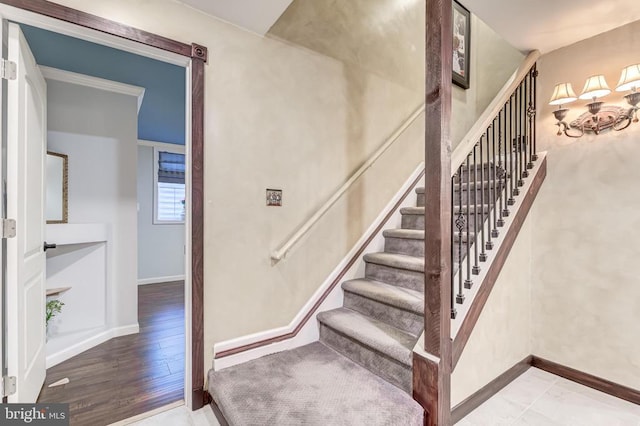 stairway featuring baseboards