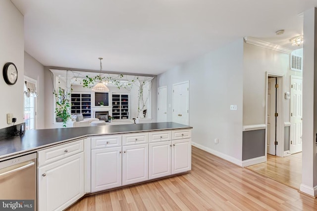 kitchen featuring white cabinets, light wood-type flooring, stainless steel dishwasher, and dark countertops
