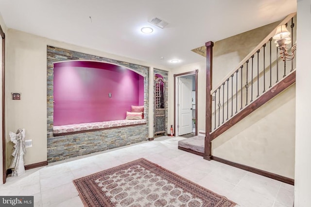 entryway featuring baseboards and stairway
