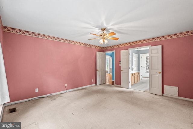 12017 Stonehenge Dr, Fredericksburg, VA 22407 - unfurnished bedroom with light colored carpet, ensuite bathroom, and a ceiling fan