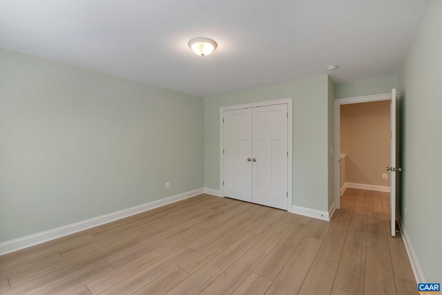 3 Lonicera Way, Charlottesville, VA 22911 - unfurnished bedroom with baseboards, light wood-type flooring, and a closet