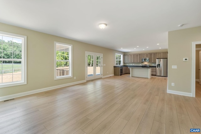 3 Lonicera Way, Charlottesville, VA 22911 - unfurnished living room featuring baseboards, light wood-style floors, french doors, and visible vents