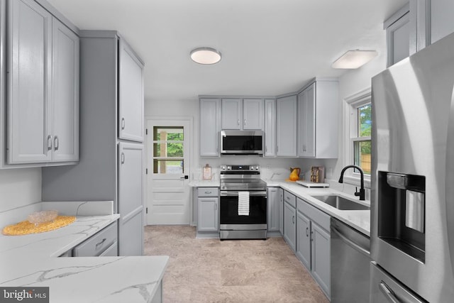 13179 Scotts Mill Rd, Culpeper, VA 22701 - kitchen featuring stainless steel appliances, a sink, gray cabinets, and light stone countertops