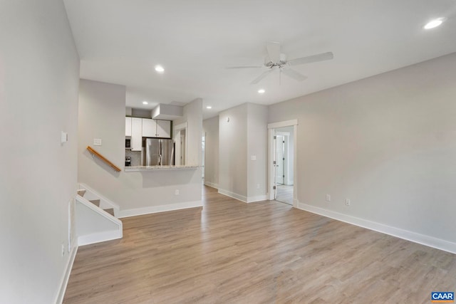 unfurnished living room with ceiling fan, baseboards, light wood finished floors, and recessed lighting