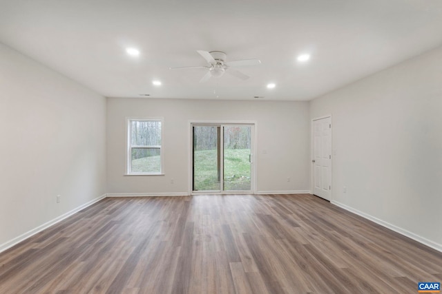 unfurnished room with wood finished floors, baseboards, ceiling fan, and recessed lighting