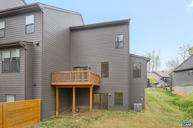 back of property featuring central AC unit and fence